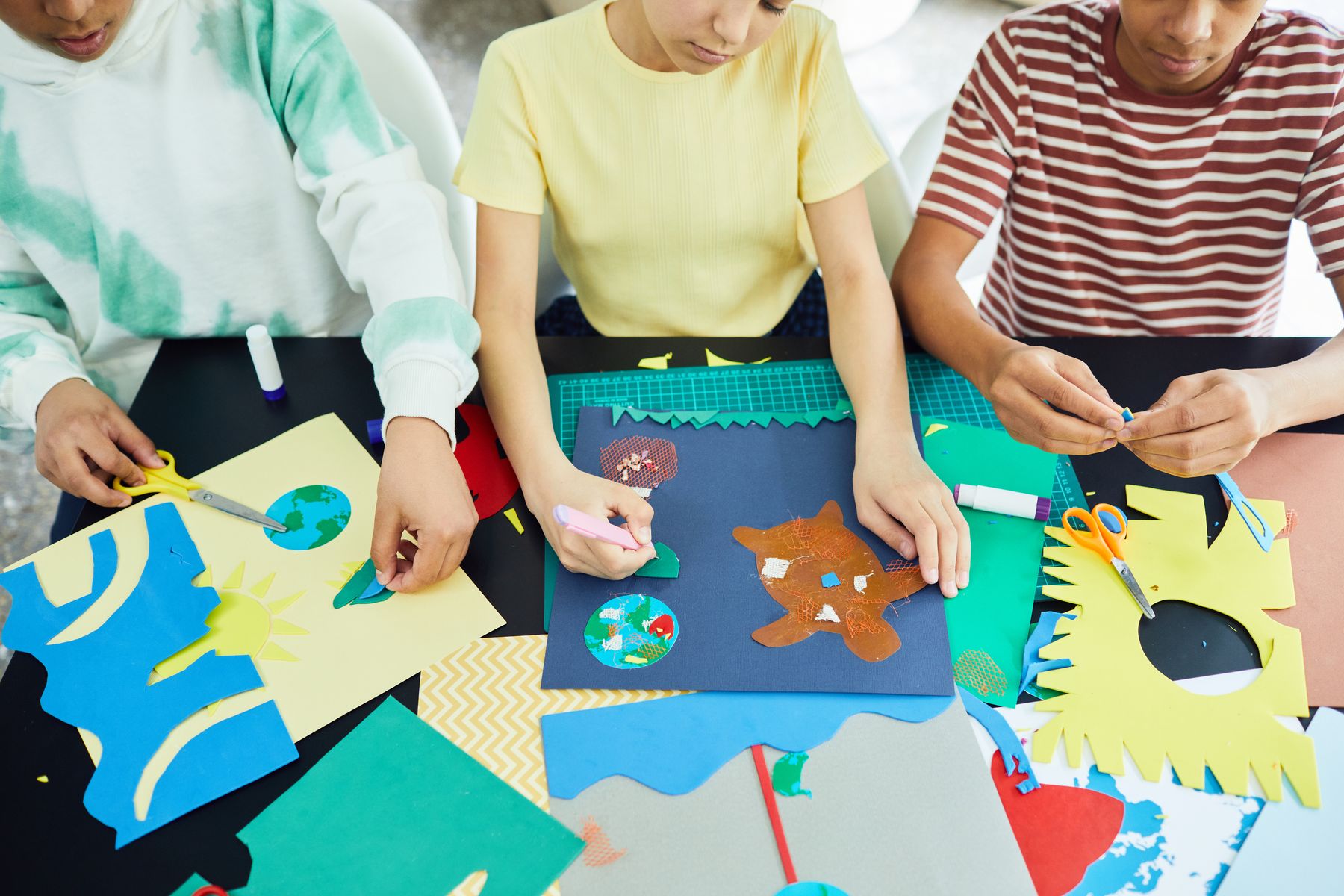 Children creating colourful craft projects together